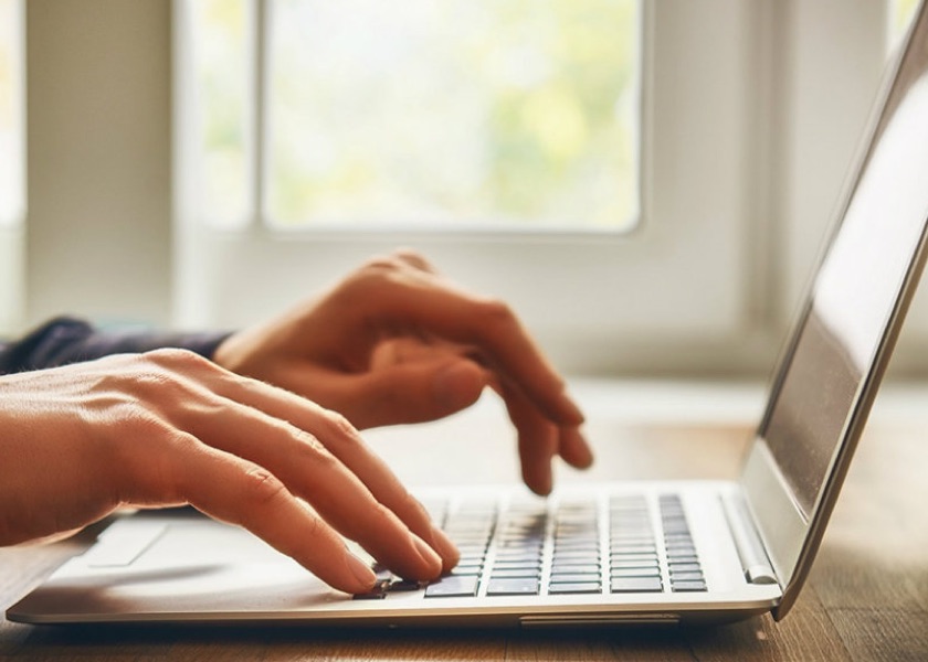 person typing on laptop